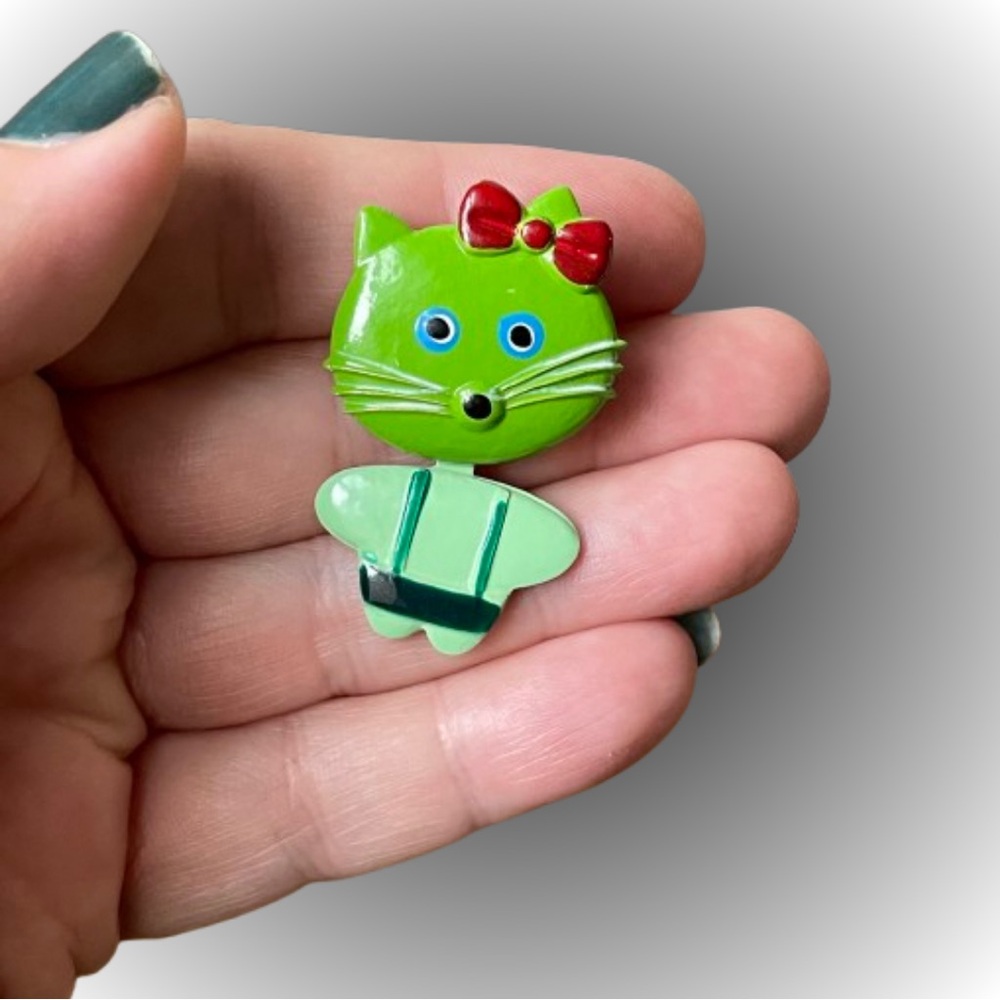 Vintage green articulated cat brooch pin red accents bow suspenders kawaii GLOWS